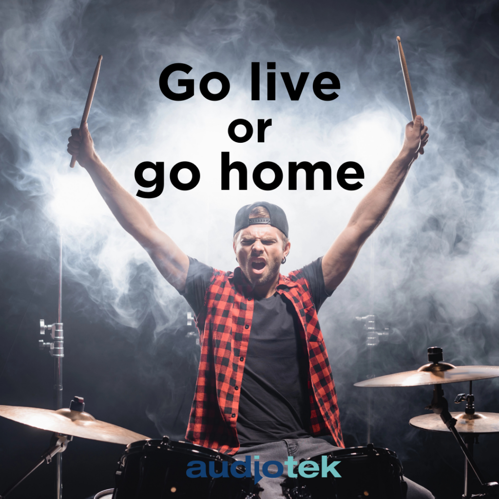 energetic drummer performing on stage with dramatic lighting and smoke effects. Text overlay reads ‘Go live or Go Home.’ Represents the excitement of converting hotels into live music venues. Audiotek branding included.